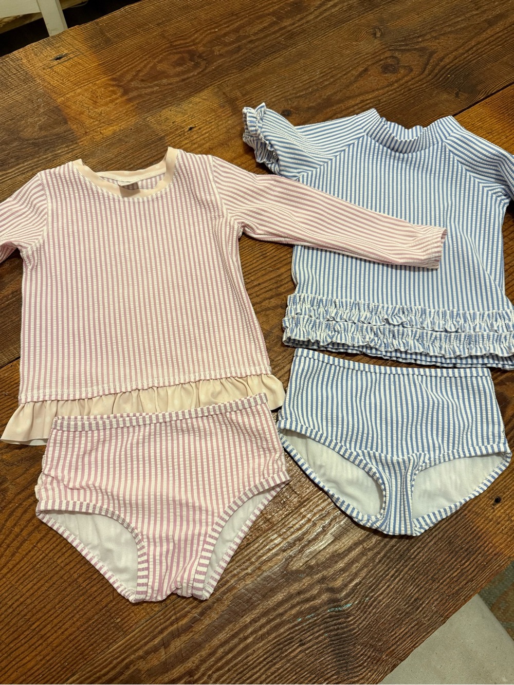 RUFFLEBUTTS- set of two seersucker swim suits with rash guards.